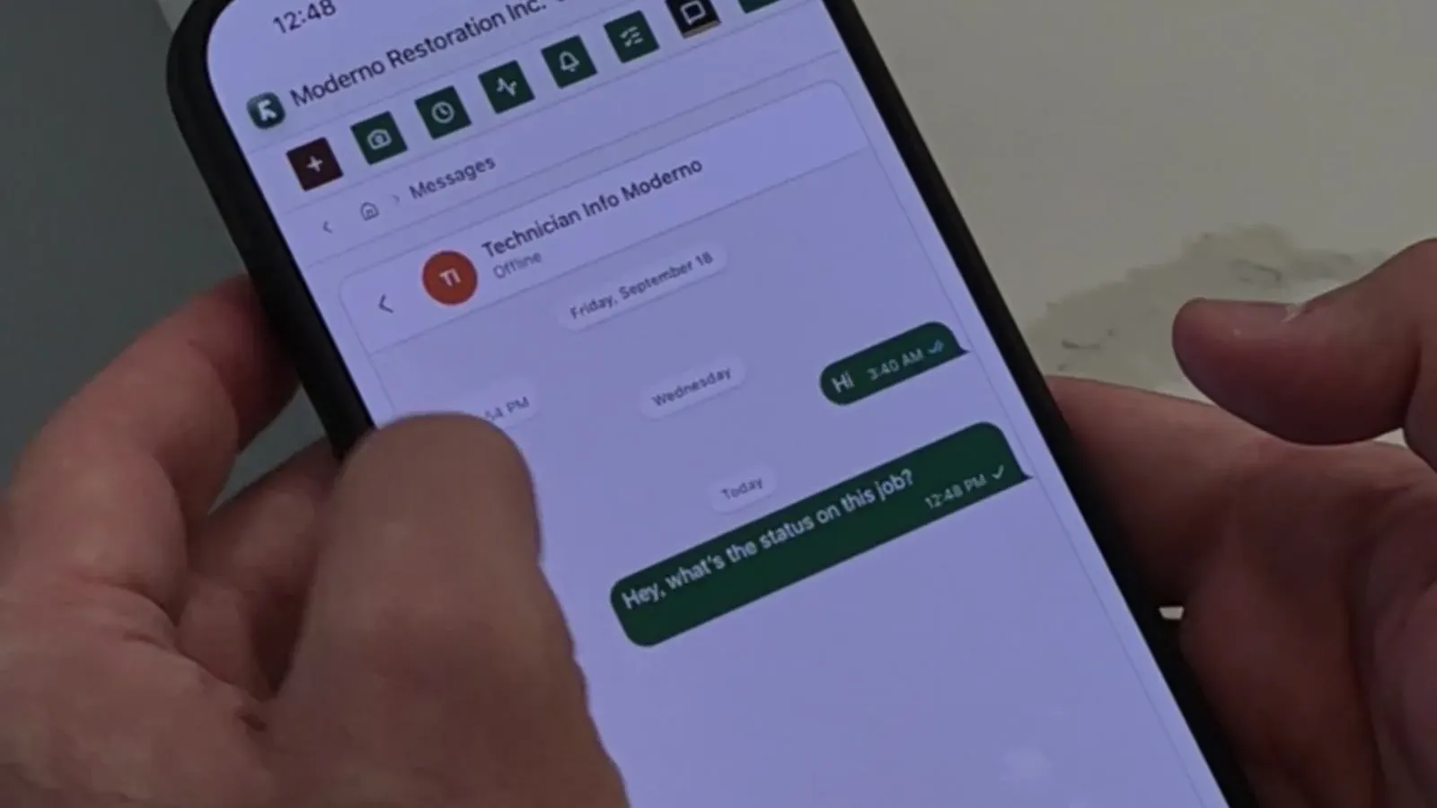 The Renovo field app on a phone: a crew message about a job's status